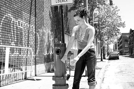 Teen girl playing with a fire hydrantの写真素材