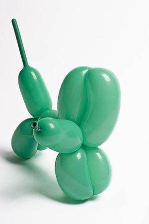 green balloon dog looking aroundの写真素材