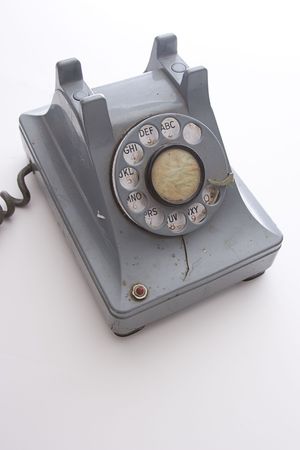dirty vintage gray unhooked rotary phone with crack casing and expose wiredの写真素材
