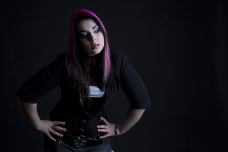 Goth girl with pink hair and body piercingの写真素材