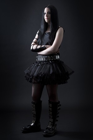 teen girl with black hair and goth style with frustrated expression wearing a black tutuの写真素材