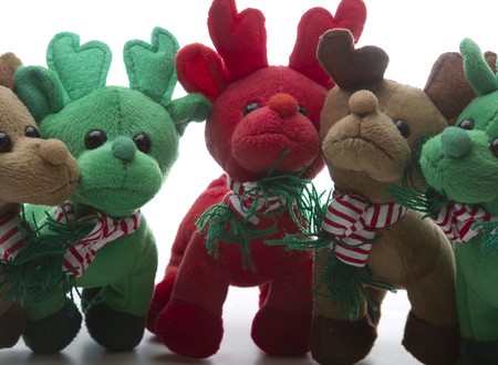 brown, green and red reindeer stuff toy, all close together for group shotの写真素材