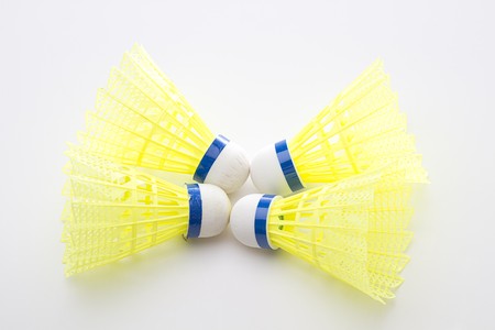 shuttlecock with yellow base with white tip head centered in the middleの写真素材