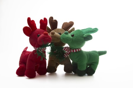 brown, green and red reindeer stuff toy, all close together for group shotの写真素材