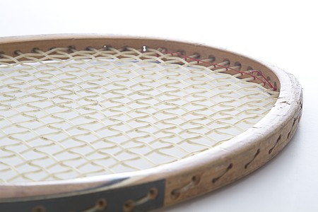close up of the head of a vintage wood tennis racket 