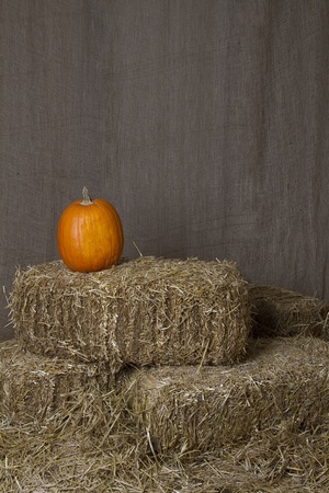 Pumpkin resting on bales of strawの写真素材