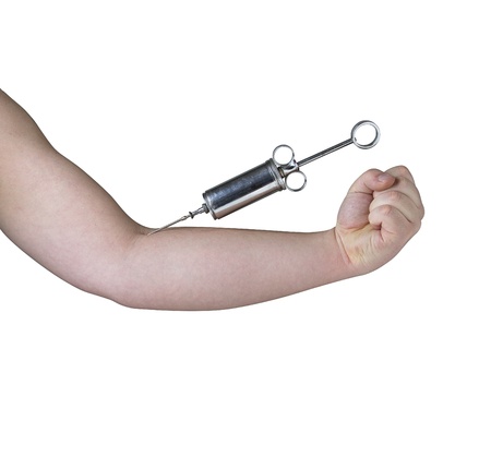 metal syringe in male arm against white backgroundの写真素材