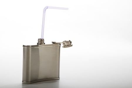 metal flask with purple straw against a white backgroundの写真素材
