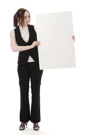 Young woman in business suit look at white sign against a white backgroundの写真素材