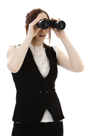 Young business woman with binoculars looking into the distance with surprise expressionの写真素材