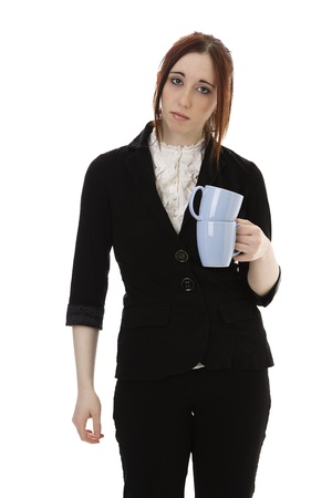 Young business woman with a stack of empty cup of coffee against white backgroundの写真素材
