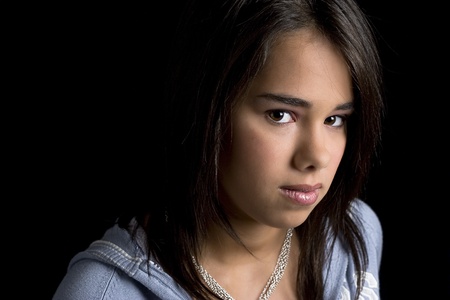 head shot of a teen girl against a black backgroundの写真素材