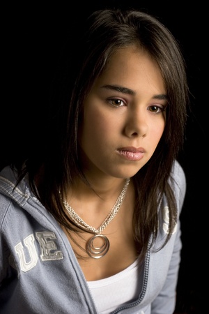 head shot of a teen girl against a black backgroundの写真素材