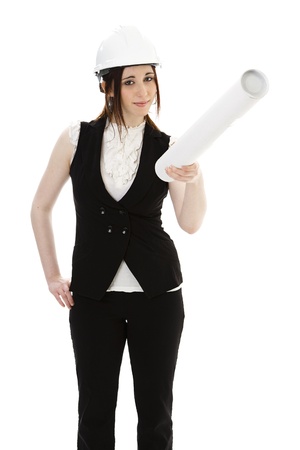 Young business woman wearing a business suit and construction had holding a white tube and pointing up against a white background の写真素材