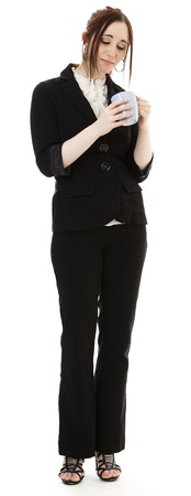 Young business woman looking into a coffee cup against white backgroundの写真素材