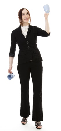 Young business woman juggling cup of coffee against white backgroundの写真素材