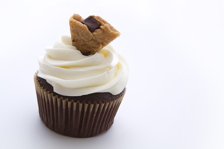 cupcake with white frosting and a cookie piece as decoration