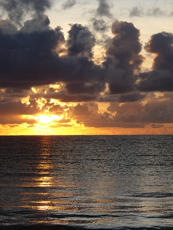 Sunrise on the ocean, during a cloudy dayの写真素材