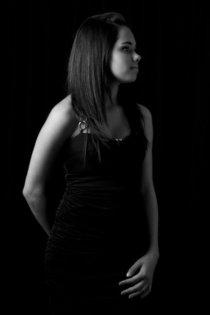 Black and white portrait of a young woman in a little black dressの写真素材
