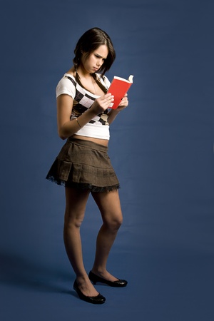 young women concentrating on reading a bookの写真素材