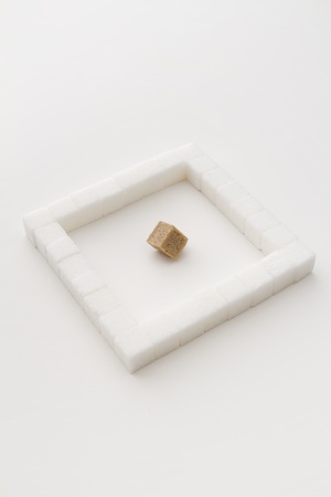 white sugar cube, place in a square, with an brown sugar square at an angleの写真素材