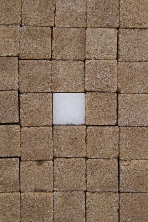 Texture of sugar cube, mostly brown with one whiteの写真素材