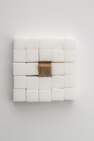  white sugar cube with one brown sugar cube place in a square shapeの写真素材