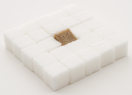  white sugar cube with one brown sugar cube place in a square shapeの写真素材