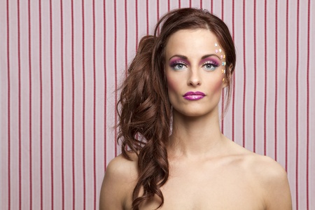 Young woman with colorful makeup and star candy glued to her face
の写真素材