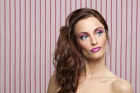 Young woman with colorful makeup and star candy glued to her face
の写真素材