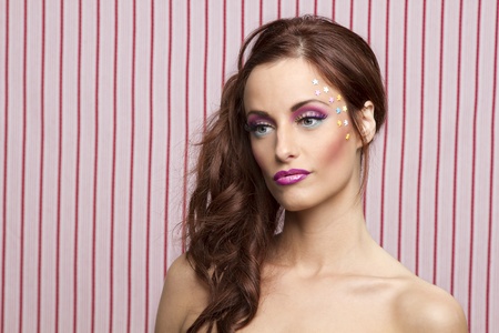 Young woman with colorful makeup and star candy glued to her face
の写真素材