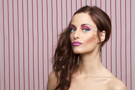 Young woman with colorful makeup and star candy glued to her face
の写真素材