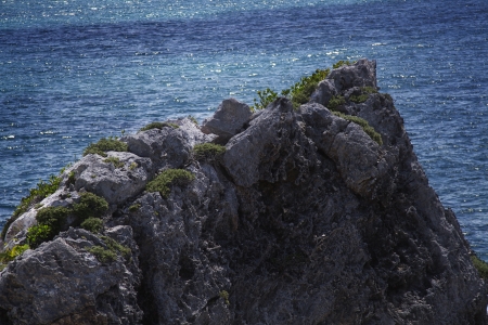 Peak of volcanic rock against an ocean backgroundの写真素材