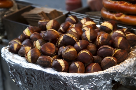bowl of roasted chesnut on street seller counterの写真素材