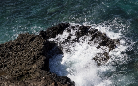 pacific ocean wave crashing on rocksの写真素材