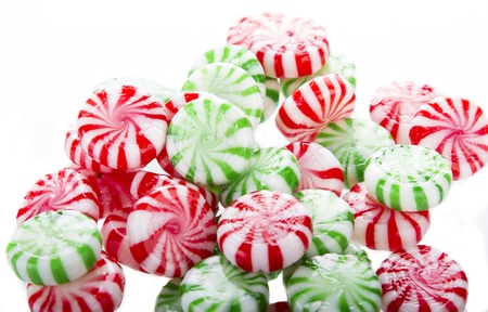 hard red, green and white candy mints placed down in messy fashionの写真素材