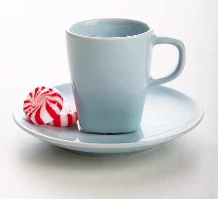 small blue coffee cup with red and white swirl mintの写真素材