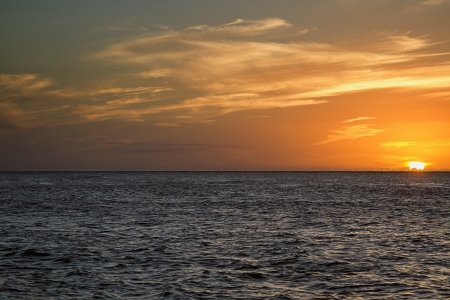 Sunset over a calm pacific oceanの写真素材