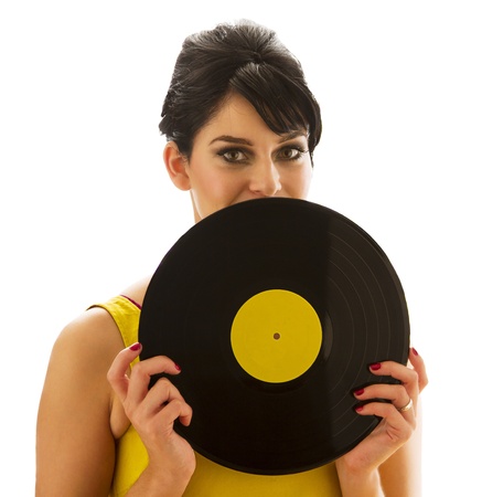 young woman in a yellow dress, looking over a record with a yellow labelの写真素材