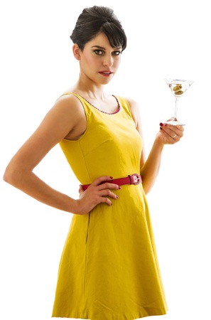 Young woman wearing a bring yellow dress having a sip of a three olive martiniの写真素材