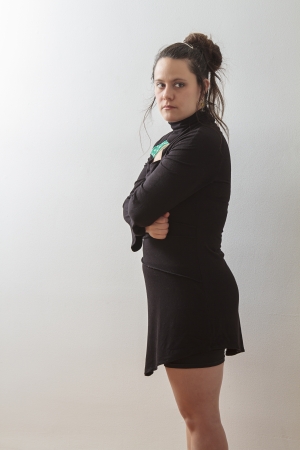 thirtie something brunette woman with arms crossed, looking annoyedの写真素材