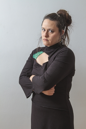woman in her thirtie with her arms crossed and an angry lookの写真素材
