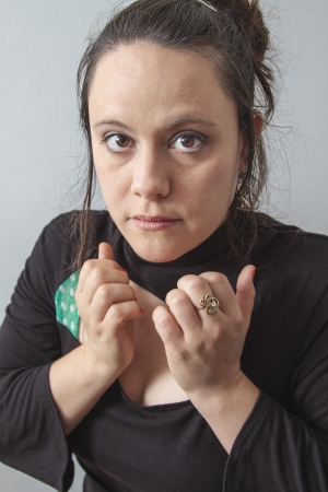 close-up portrait of a thirtie something brunette woman with nervous expressionの写真素材