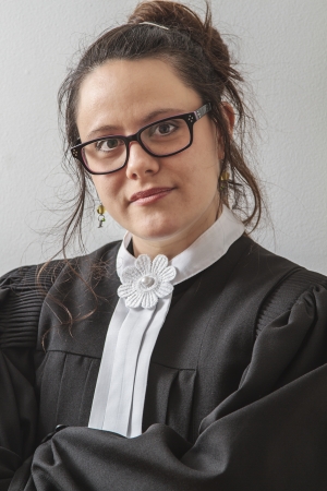 thirtie something brunette woman wearing a canadian lawyer toga with her arm foldedの写真素材
