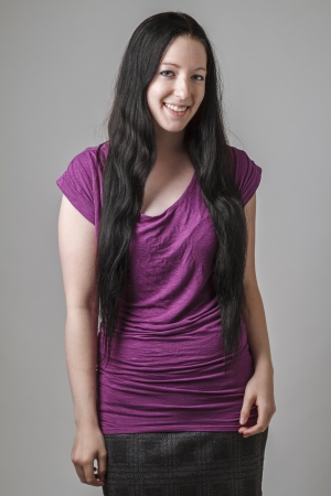 young woman with long black hair and a purple shirtの写真素材