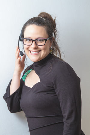 thirty something phone agent with headset and a great big smileの写真素材