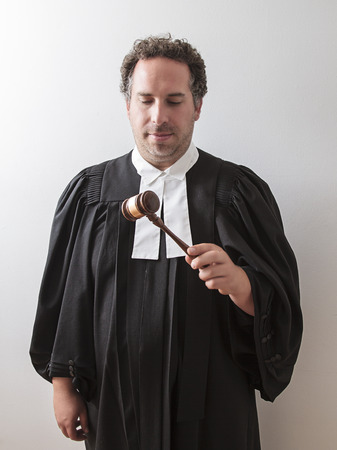 thirty something attorney looking at the gavel in his handの写真素材