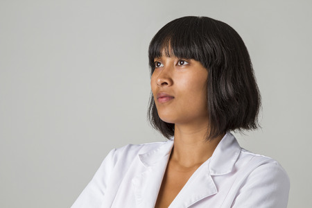 portrait of a twenty something philipino doctor  against white backgroundの写真素材