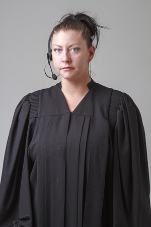 thirty something woman, wearing a preacher robe and phone headsetの写真素材