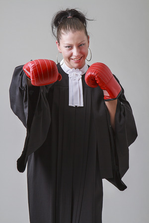 thirty something lawyer woman throwing a punchの写真素材